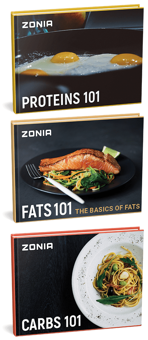 Three Zonia books are displayed: "Proteins 101" with a cover showing fried eggs in a pan, "Fats 101" featuring a salmon fillet with vegetables, and "Carbs 101" showing a plate of spaghetti.